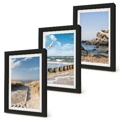 Set van ingelijste schilderijen Strand met houten pad, zee en kliffen aan zee.