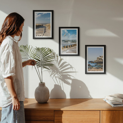 Set van ingelijste schilderijen Strand met houten pad, zee en kliffen aan zee.