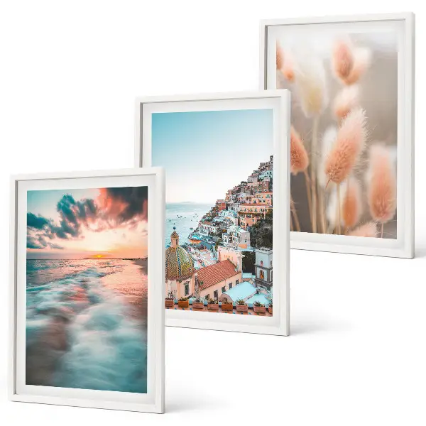 Fotowand met een zonsondergang bij de zee met huizen en bloemen