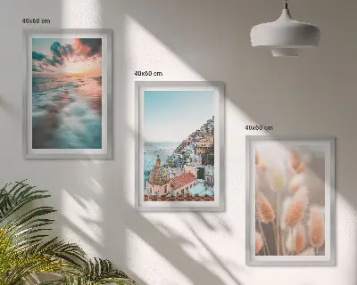 Fotowand met een zonsondergang bij de zee met huizen en bloemen
