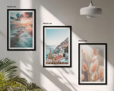 Fotowand met een zonsondergang bij de zee met huizen en bloemen