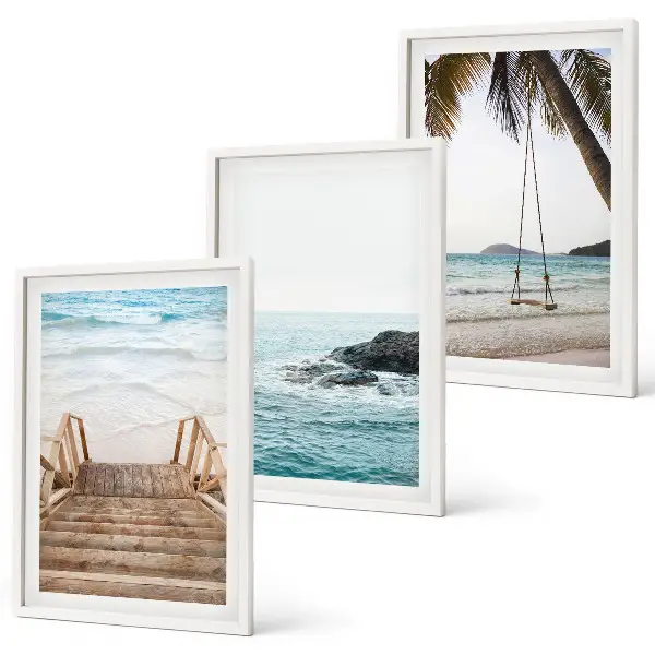 Wanddecoratieset schilderijen met een trap bij het strand en een schommel aan de zee